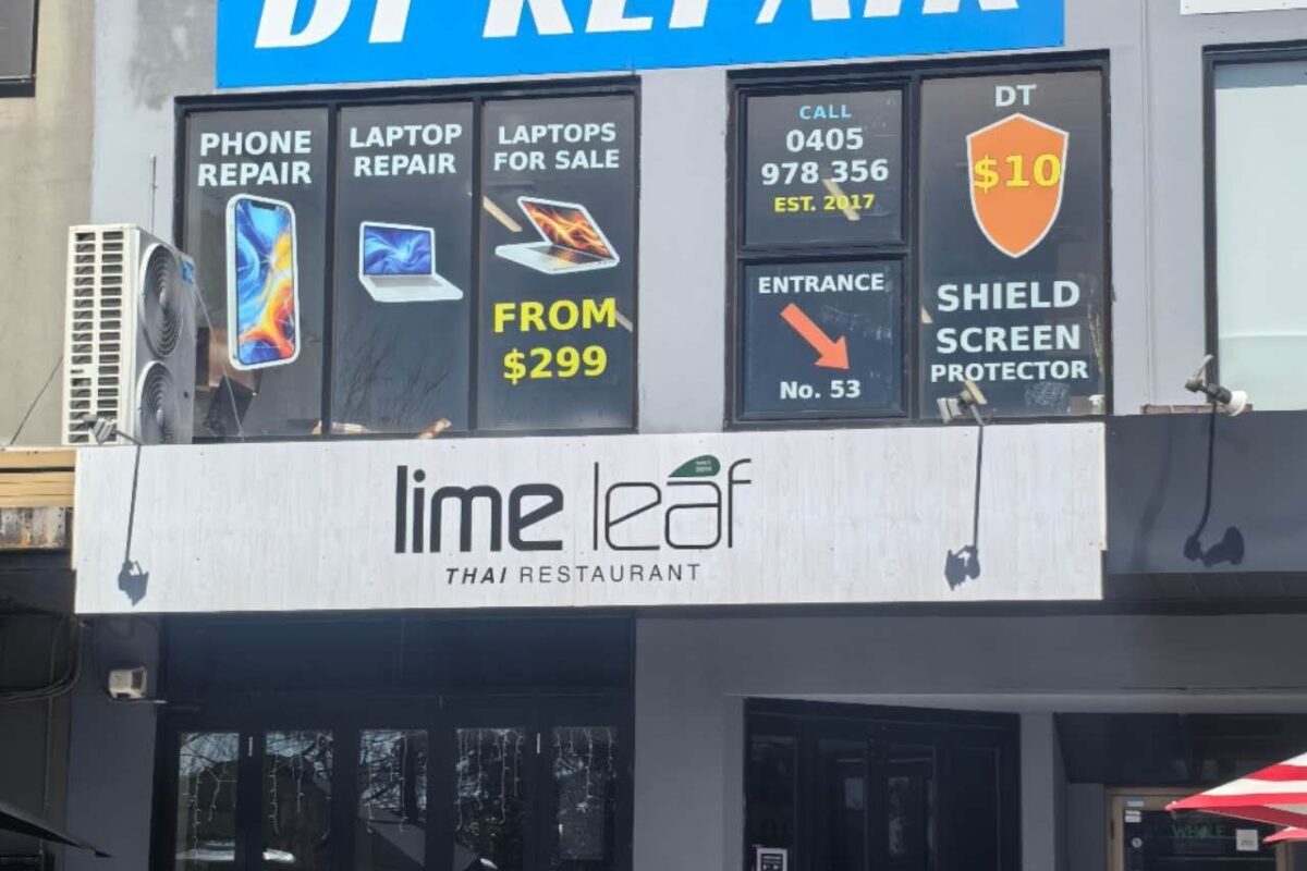 The blue DT Repair sign above the shops at Mountain Gate, Ferntree Gully, advertising phone repair, laptop repair and laptops for sale