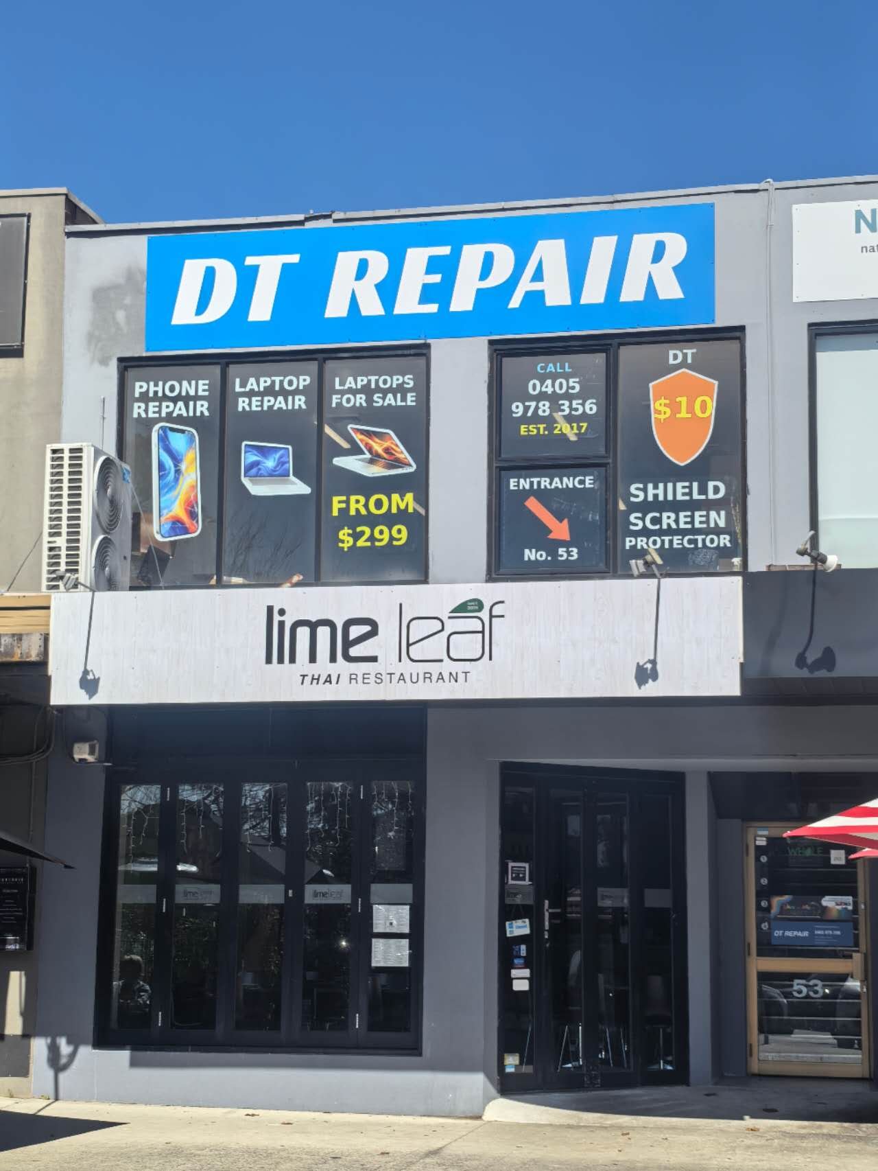 The blue DT Repair sign above the shops at Mountain Gate, Ferntree Gully, advertising phone repair, laptop repair and laptops for sale