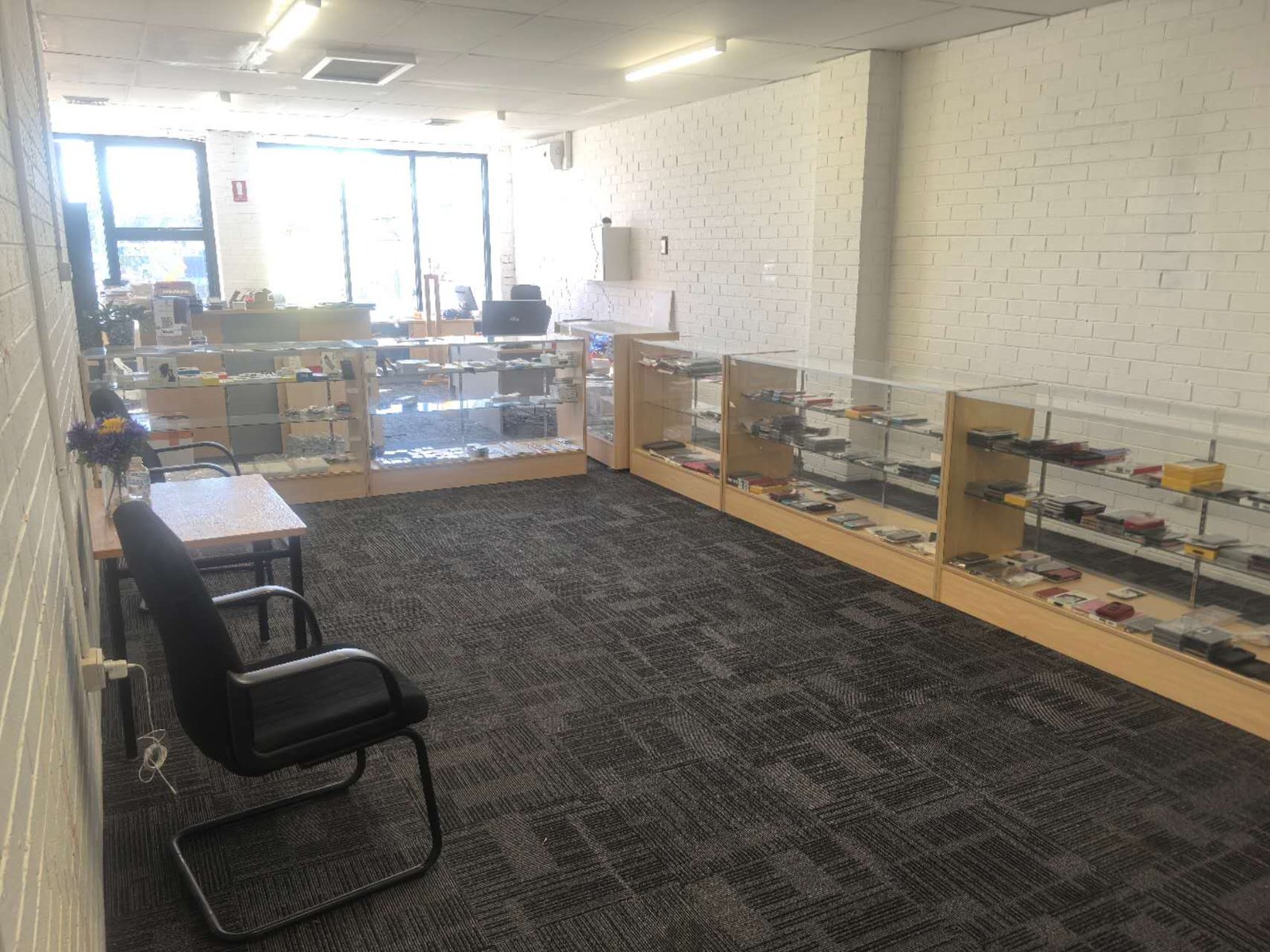 Inside the DT Repair workshop upstairs at Mountain Gate, with stock displayed in glass cabinets
